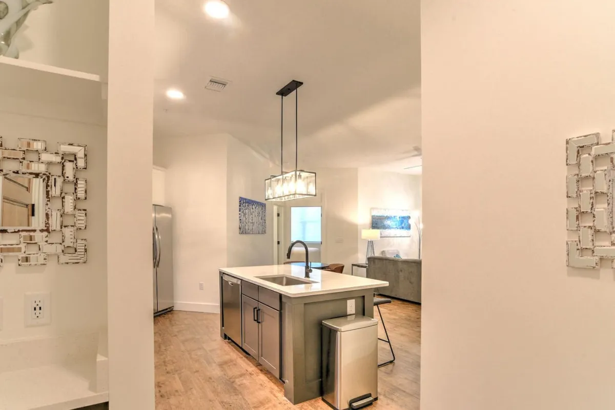 This interior scene highlights the kitchen island, modern appliances, and a welcoming layout. The space feels inviting and stylish, showcasing both comfort and practicality for daily living or entertaining.